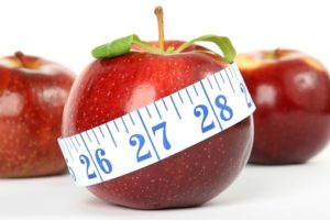 a tape measure and an apple