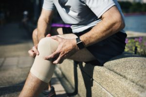 a person holding his knee